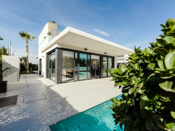 white and grey concrete building near swimming pool under clear sky during daytime